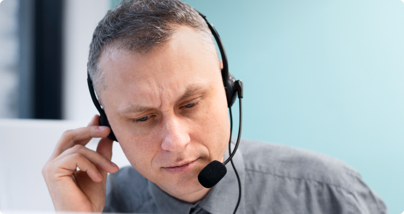A contact center agent with a headset speaks to a customer, providing a truly personalized experience.